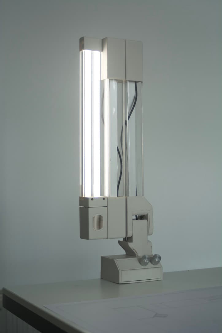 SOL-ONE folded upright on a desk, its light tube glowing